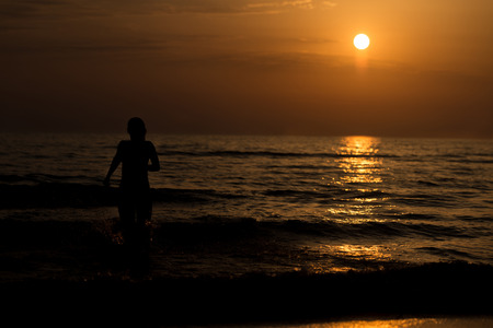 Sexy Girl Silhouette On The Beach At Sunset Over The Sea - Copy Space Textの写真素材