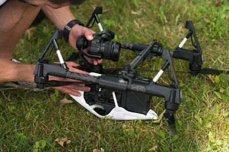 Closeup of Young Engineer Man Checking the Camera from a Drone With Hand in Park