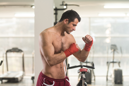 Handsome Man In Red Boxing Gloves - Boxing In Gym - The Concept Of A Healthy Lifestyle - The Idea For The Film About Boxingの写真素材
