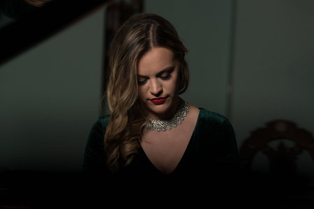 Beautiful Thoughtful Girl Sitting Near Piano - Fashion Studio Portrait