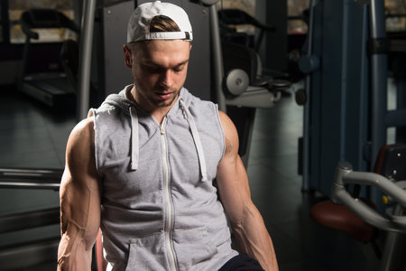 Leg Exercises Close Up -  Man Doing Leg With Machine In Gym