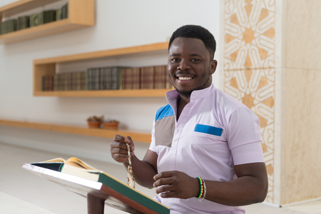 Black African Muslim Man Is Reading The Koranの写真素材