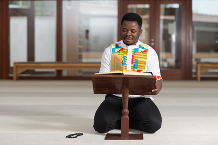 Black African Muslim Man Is Reading The Koranの写真素材
