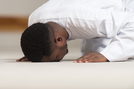 African Muslim Man Making Traditional Prayer To God While Wearing A Traditional Cap Dishdashaの写真素材