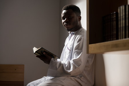 African Muslim Man Making Traditional Prayer To God While Wearing A Traditional Cap Dishdashaの写真素材