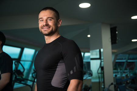 Personal Trainer And client In Gym On Treadmillsの写真素材