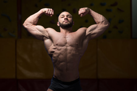 Portrait Of A Young Physically Fit Man Showing His Well Trained Body - Muscular Athletic Bodybuilder...