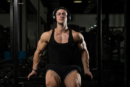 Resting Time - Confident Muscled Young Man Resting In Healthy Club Gym After Exercisingの写真素材