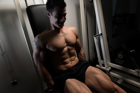 Leg Exercises - Man Doing Leg With Machine In Gymの写真素材