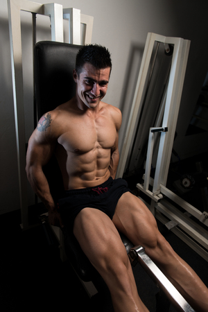 Leg Exercises - Man Doing Leg With Machine In Gymの写真素材