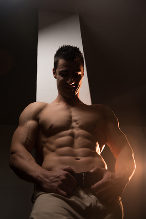 Muscular Man Resting After Exercises - Portrait Of A Physically Fit Young Man Without A Shirtの写真素材