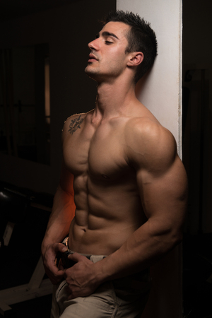 Muscular Man Resting After Exercises - Portrait Of A Physically Fit Young Man Without A Shirtの写真素材