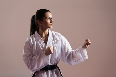 Young Woman Dressed In Traditional Kimono Practicing Her Karate Moves - Black Beltの写真素材