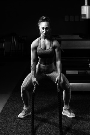 Battling Ropes Young Woman At Gym Workout Exerciseの写真素材