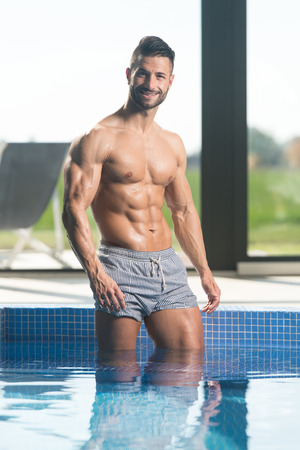 Young Healthy Good Looking Macho Man Model Athlete At Hotel Indoor Poolの写真素材