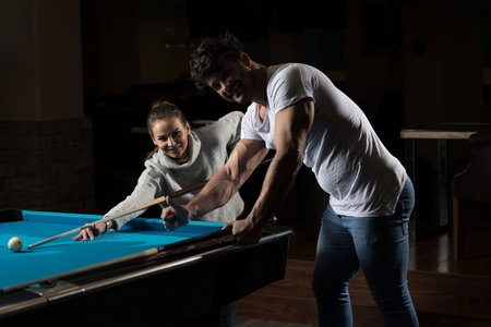 Young Caucasian Woman Receiving Advice On Shooting Pool Ball While Playing Billiards