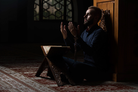 Adult Muslim Man Is Reading The Koran In The Mosqueの写真素材