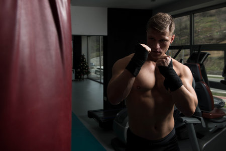 Young Man Boxing On Bag - Boxing In A Gym - The Concept Of A Healthy Lifestyle - The Idea For The...