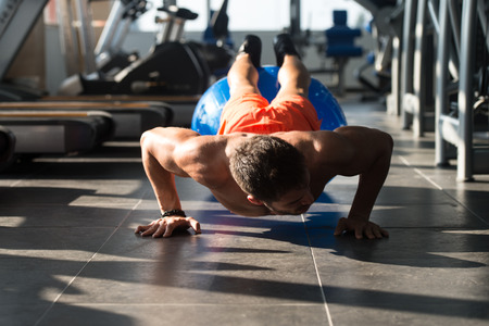 Young Model Doing Push Ups As Part Of Bodybuilding Trainingの写真素材