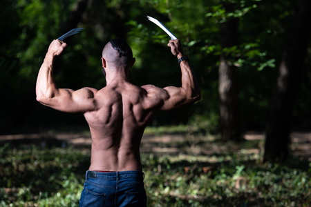 Wolverine With Claws Standing Strong Outdoors and Flexing Muscles - Athletic Superhero Posingの写真素材