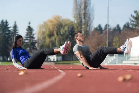 Attractive Couple Exercising in City Park Area - Training and Exercising for Endurance - Fitness Healthy Lifestyle Concept Outdoorの写真素材