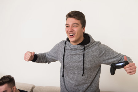 Two Men Competitive Friends Playing Video Games and Excited Happy Cheerful at Home