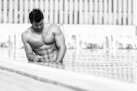 Fashion Portrait Of A Very Muscular Sexy Man In Swimsuit At Swimming Poolの写真素材