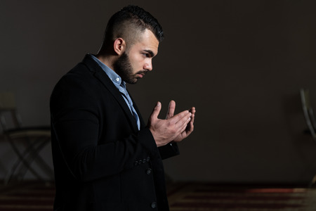 Attractive Man Making Traditional Prayer to God Allah in the Mosqueの写真素材
