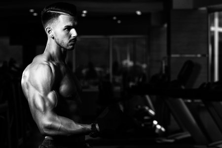 Man Working Out Biceps In A Gym - Dumbbell Concentration Curls