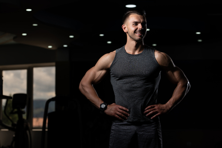 Portrait Of A Young Physically Fit Man Showing His Well Trained Body - Muscular Athletic Bodybuilder Fitness Model Posing After Exercisesの写真素材