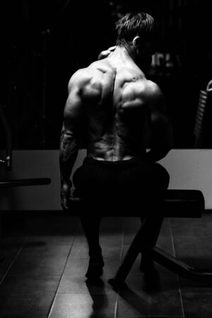Middle Age Man Bodybuilder Flexing Back Poseの写真素材