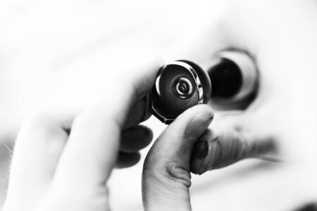 Jeweler Polishing A Gold Ring At Workbench - Goldsmith Making A Ring At Her Work Shop Using Toolsの写真素材