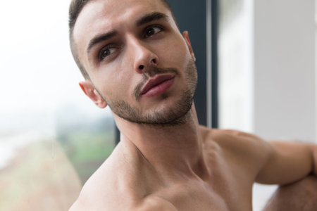 Healthy Young Man Standing Strong In The Gym And Flexing Muscles - Muscular Athletic Bodybuilder...