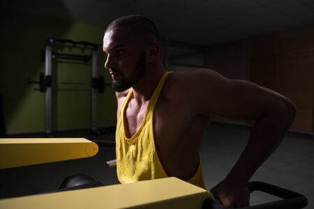 Man Doing Heavy Weight Exercise For Trapezius On Machineの写真素材