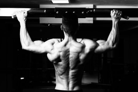 Bodybuilder Doing Pull Ups Best Back Exercises