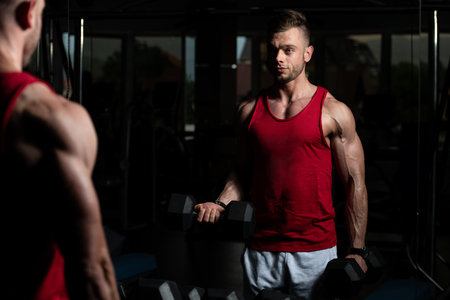 Man Working Out Biceps In A Gym - Dumbbell Concentration Curls