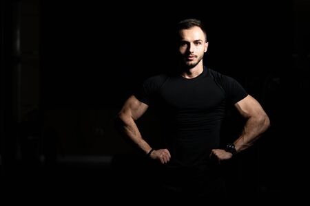 Portrait Of Personal Trainer In Sports Outfit In Fitness Center Gym Standing Strongの写真素材