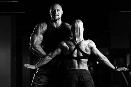 Portrait Of A Sexy Couple In The Gym With Exercise Equipmentの写真素材