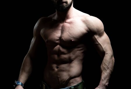 Young Bodybuilder Flexing Muscles - Isolate on Black Blackground - Copy Spaceの写真素材