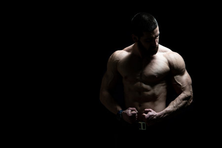 Young Bodybuilder Flexing Muscles - Isolate on Black Blackground - Copy Space