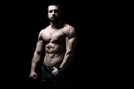 Young Bodybuilder Flexing Muscles - Isolate on Black Blackground - Copy Spaceの写真素材