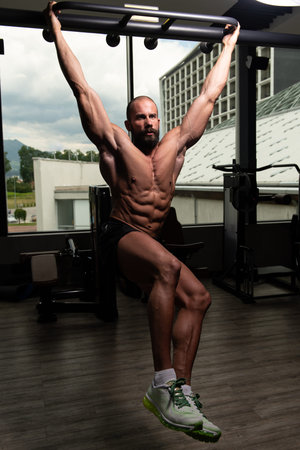 Man Performing Hanging Leg Raises Exercise - One Of The Most Effective Ab Exercises