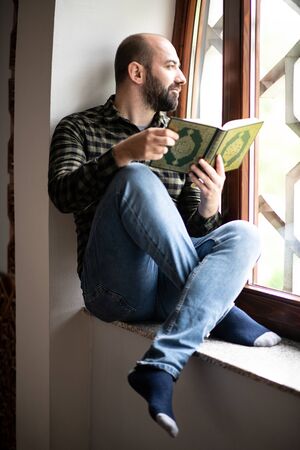 Beard Muslim Man Reading Holy Islamic Book Koranの写真素材