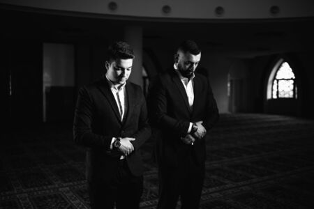 Two Businessman Muslim Making Traditional Prayer to God Allah in the Mosqueの写真素材