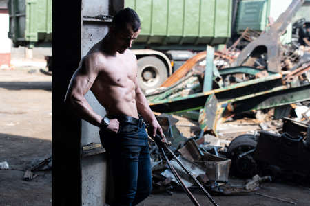 Young Man Athlete Welder is Holds the Gas Torch in His Hand the Fire and the Flame Burns From the Nozzleの写真素材