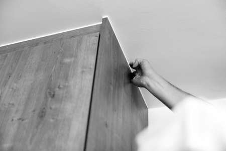 Construction Worker Use Finger Applying Silicone for Repairing and Installing Kitchen in Houseの写真素材