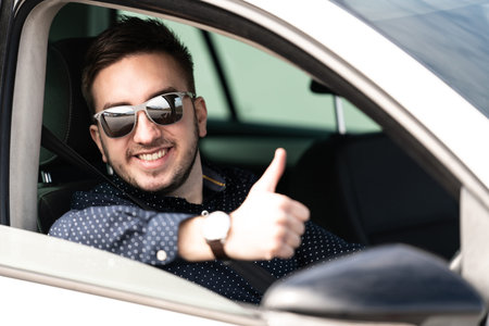 Man Driver in His Car and Showing Thumbs Up