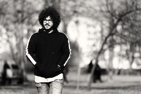 Portrait of Stylish Arab Beard Afro Man on a Background of Autumn Leaves