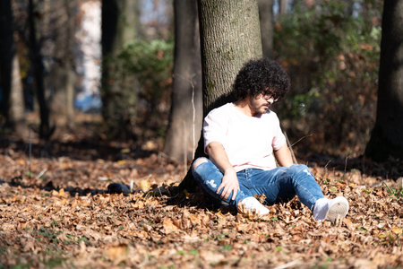 Portrait of Stylish Arab Beard Afro Man on a Background of Autumn Leaves