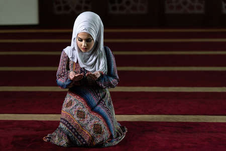 Humble Muslim Woman Is Praying in the Mosqueの写真素材
